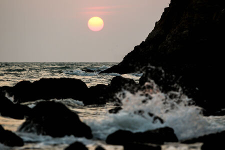 Sunset and sea wave silhouetted background の写真素材