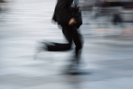 The motion blur of walking man in city の写真素材