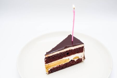 Chocolate cake with burning birthday candle.の写真素材