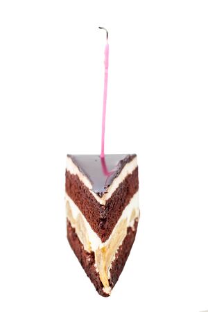 Chocolate cake with burning birthday candle.の写真素材