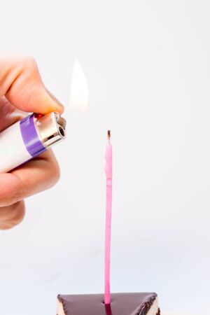 Chocolate cake with burning birthday candle.の写真素材