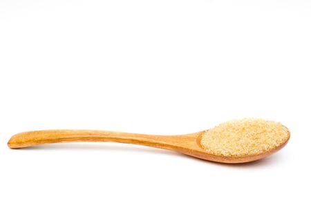 Brown sugar on wooden spoon isolated.の写真素材