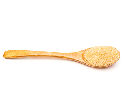Brown sugar on wooden spoon isolated.の写真素材