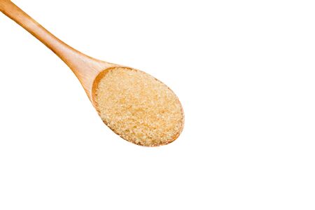 Brown sugar on wooden spoon isolated.の写真素材