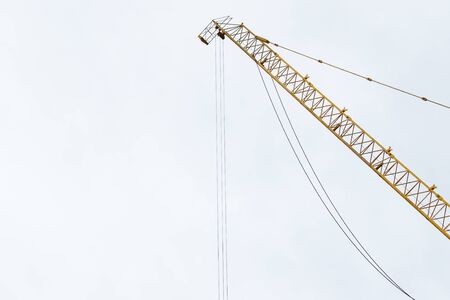 Power crane arm in under construction close up.の写真素材