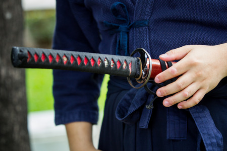The treaditional Japanese sword Katana sword holding in Samurai hand prepare to flighting.の写真素材