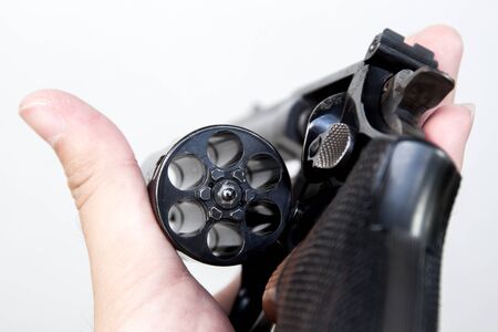 The revolver hand gun holding on hand in white background.の写真素材