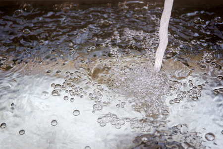 Flowing water into sink.の写真素材