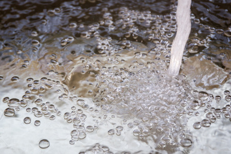 Flowing water into sink.の写真素材