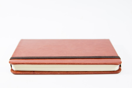 Small brown notebook isolated in white background.の写真素材