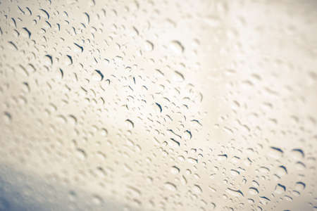 Rain drop on glass background.(Processed in vintage colour tone)の写真素材