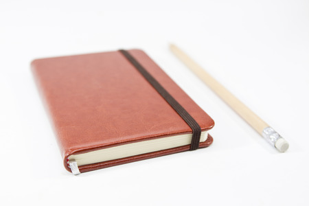Small brown notebook isolated in white background.の写真素材