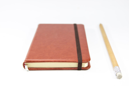 Small brown notebook isolated in white background.の写真素材
