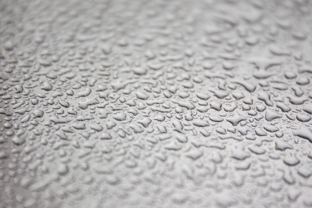 Rain drop on car roof close up.の写真素材