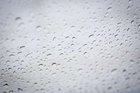 Rain drop on glass window background.の写真素材