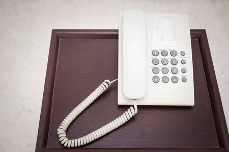 Old telephone on the wooden table close up.の写真素材