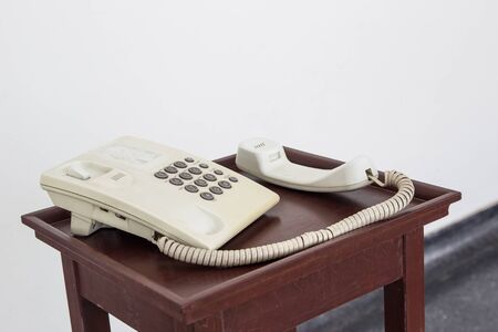 Old telephone on the wooden table close up.の写真素材