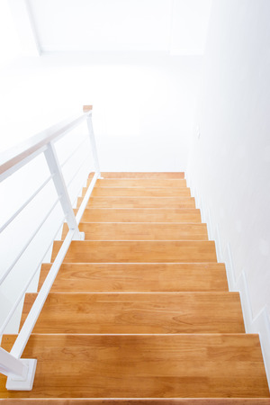 The modern wooden stair way in home close up.の写真素材