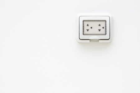 Electric plug socket with protection flip case close up.
