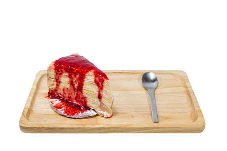 Strawberry crape cake on wooden plate isolated.の写真素材