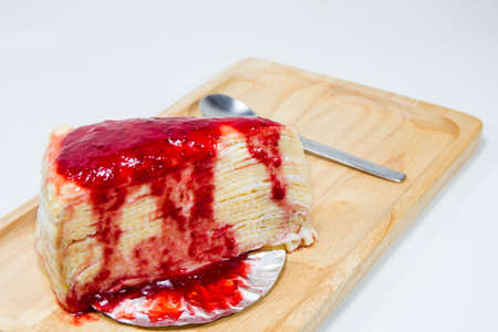 Strawberry crape cake on wooden plate isolated.の写真素材