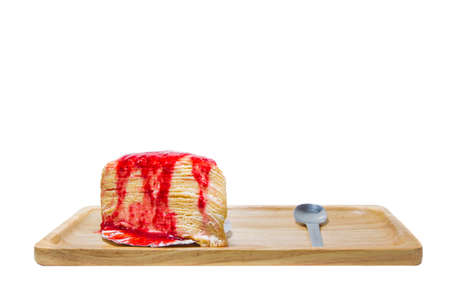 Strawberry crape cake on wooden plate isolated.の写真素材