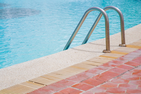 Public swimming pool and ladder close up.の写真素材