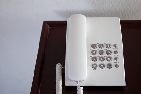 Old telephone on the wooden table.の写真素材
