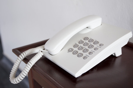 Old telephone on the wooden table.の写真素材