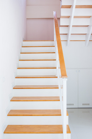 The modern wooden stair way in home close up.の写真素材