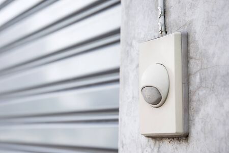 Eletronic old doorbell set up in house concrete wall close up.の写真素材