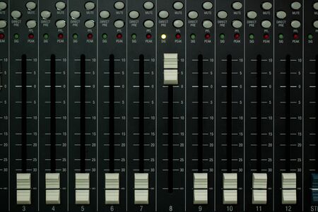 Audio mixer board close up on each channel controller.の写真素材