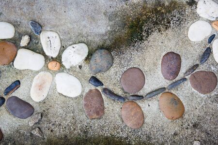 Native art, ceramic flowers on old concrete brick close up background.の写真素材