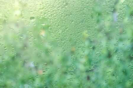 Small dew out side the window in the morning close up background.の写真素材