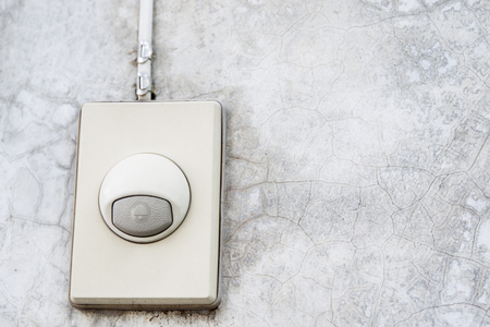 Eletronic old doorbell set up in house concrete wall close up.の写真素材