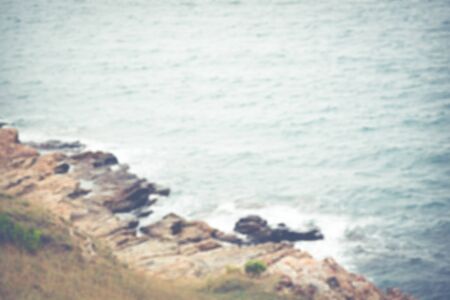 Blur image of rocky mountain and ocean background.(processed in vintage colour tone)の写真素材