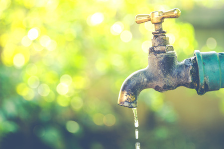 Brass water tap in nature background.(Processed in vintage colour tone)の写真素材