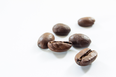 Organic coffee beans in white background close up.の写真素材