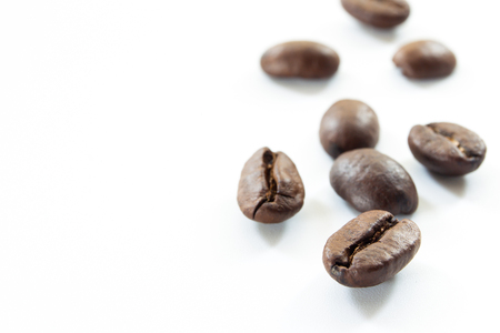 Organic coffee beans in white background close up.の写真素材