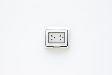 Electric plug socket with protection flip case close up.の写真素材
