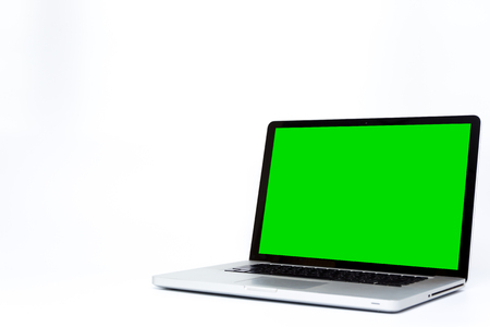 Photograph of 15 inch laptop computor with green screen isolated on white background close up.の写真素材