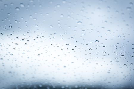 Rain drop on car glass in background.の写真素材