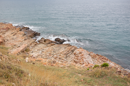 Rocky mountain and ocean background.(Processed in vintage colour tone)の写真素材