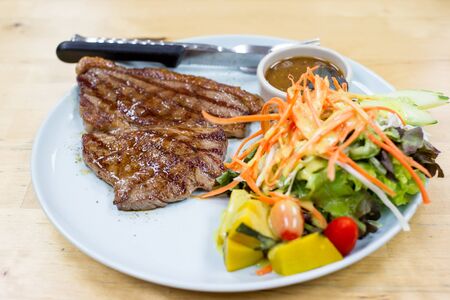 Medium well beef steak with salad close up.の写真素材