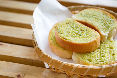 Garlic grilled bread in wooden basket close up.の写真素材