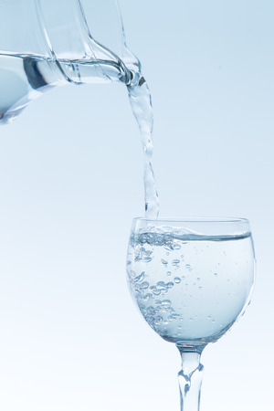 Mineral water in tulip glass close up.の写真素材