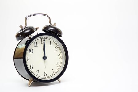 Classic alarm clock on the bed close up.の写真素材