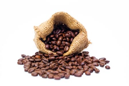 Organic coffee beans in sack on white background close up isolated.の写真素材