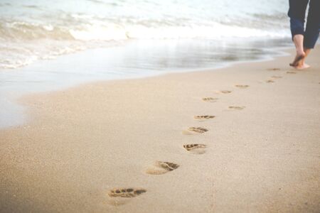 Women was walking a long the beach when evening sunset time.