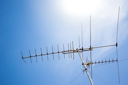 Old antenna in blue sky background.の写真素材